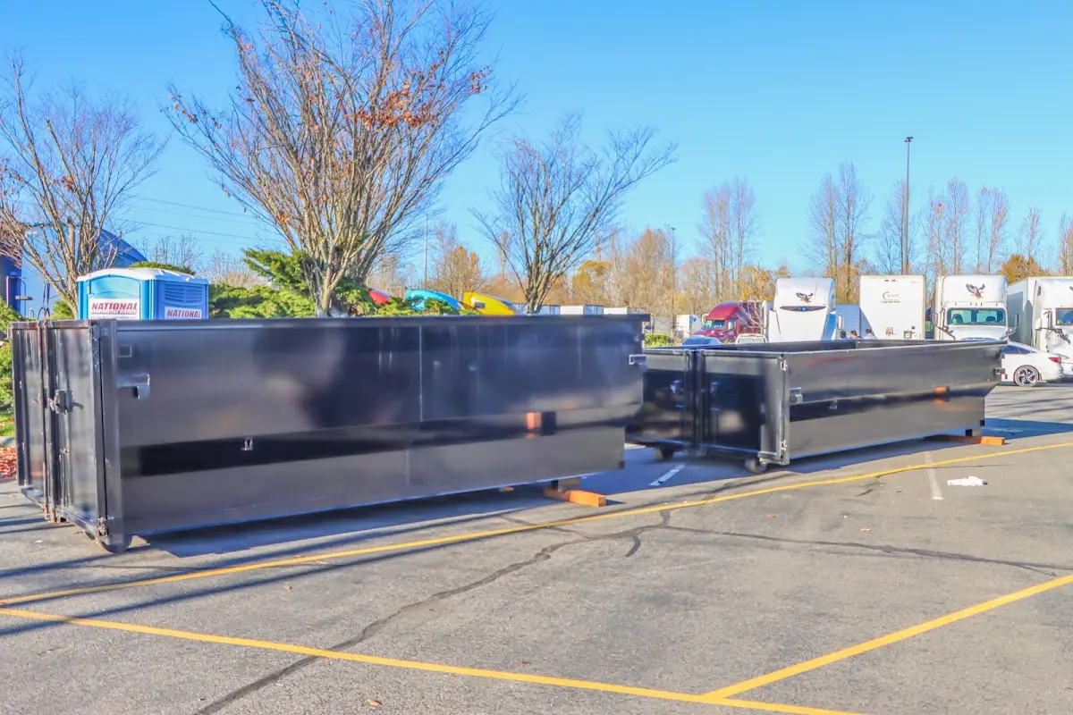 Professional dumpster rental service with roll-off container on residential driveway in Denair